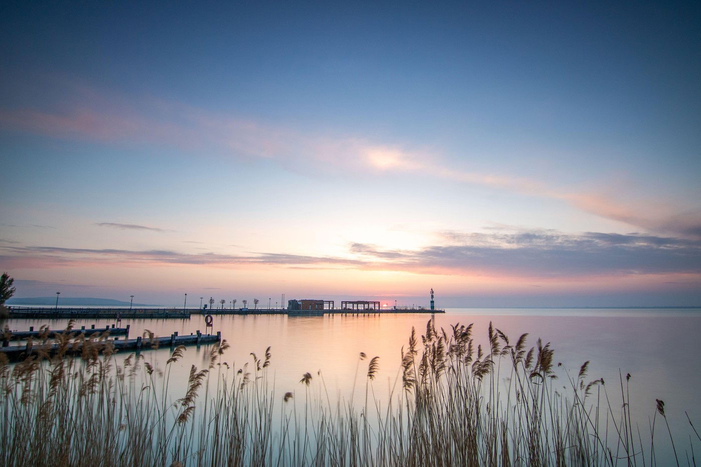 Sunrise at the shore and harbor of a lake in summer. Tihany Marina, Lake Balaton, Siófok, Hungary